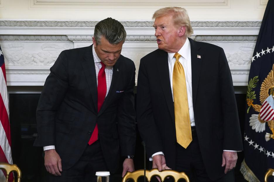 US President Donald Trump speaks to US Secretary of Defense Pete Hegseth during a roundtable.