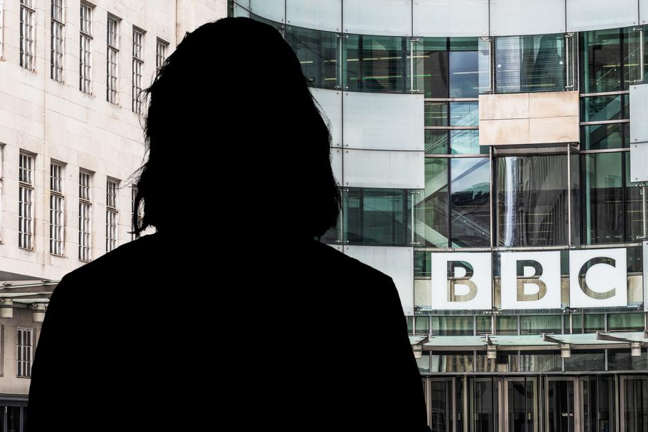 Silhouette of a person in front of the BBC building.