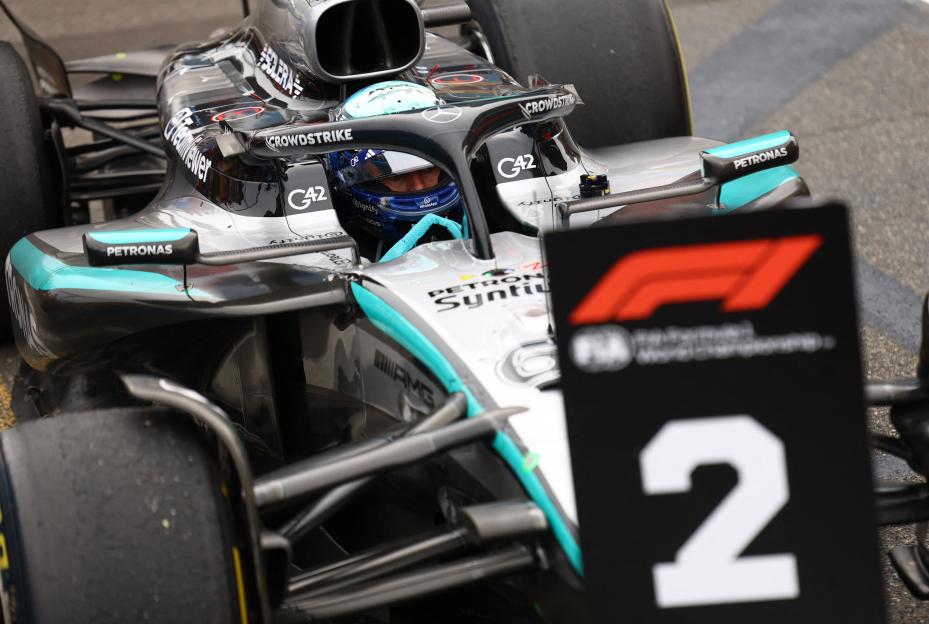 George Russell in a Mercedes F1 car, with a number two sign in the foreground.