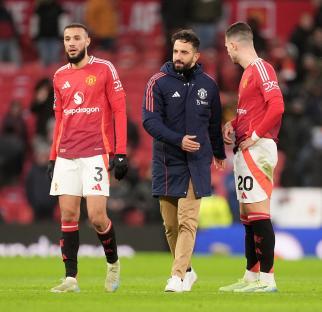 Manchester United manager and players looking dejected after a match.