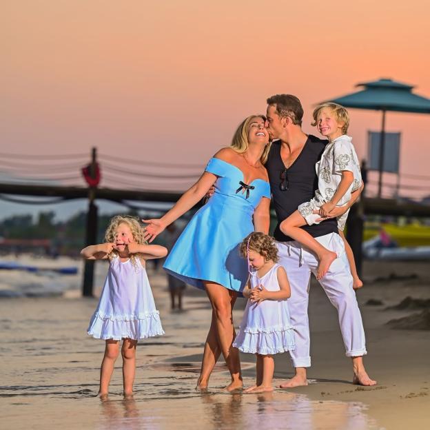 Family on a beach at sunset.